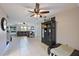 The spacious living room features neutral tile flooring, ceiling fan, and natural light at 404 62Nd Nw St, Bradenton, FL 34209
