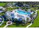 Stunning aerial view of the community pool area with lush landscaping and ample lounge space at 4162 Deep Creek Ter, Parrish, FL 34219