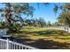 Expansive backyard with lush green grass and mature trees, creating a serene outdoor space at 4162 Deep Creek Ter, Parrish, FL 34219
