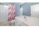 Bright bathroom featuring a shower/tub combo, floral shower curtain, and a white vanity at 4162 Deep Creek Ter, Parrish, FL 34219