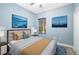 Cozy bedroom with calming blue walls, comfortable bed, and nautical themed wall decor at 4162 Deep Creek Ter, Parrish, FL 34219