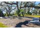 Cornhole boards under large, mature trees, creating a fun and shaded outdoor recreational space at 4162 Deep Creek Ter, Parrish, FL 34219