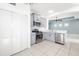Well-lit kitchen with gray cabinets, stainless steel appliances, and easy access to laundry room at 4162 Deep Creek Ter, Parrish, FL 34219
