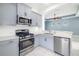 Modern kitchen with gray cabinets, quartz counters, and stainless steel appliances at 4162 Deep Creek Ter, Parrish, FL 34219