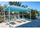 Relaxing lounge area with shaded canopy and comfortable seating overlooking lush landscaping at 4162 Deep Creek Ter, Parrish, FL 34219