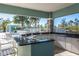 Outdoor kitchen with granite counters, stainless steel sink, and space for seating at 4162 Deep Creek Ter, Parrish, FL 34219