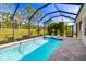 Screened-in pool with a spa and landscaped backyard at 4162 Deep Creek Ter, Parrish, FL 34219