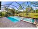 Screened-in pool with a spa and landscaped backyard at 4162 Deep Creek Ter, Parrish, FL 34219