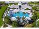 Aerial view of a stunning community pool surrounded by lush landscaping and comfortable lounging areas at 4162 Deep Creek Ter, Parrish, FL 34219