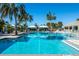 Community pool featuring lounge seating, cabanas and mature palms at 4162 Deep Creek Ter, Parrish, FL 34219