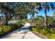 Paved walking path surrounded by lush tropical landscaping and mature trees at 4162 Deep Creek Ter, Parrish, FL 34219
