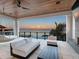 Relaxing covered balcony showcases panoramic waterfront views, blending indoor and outdoor living at 424 Bowdoin Cir, Sarasota, FL 34236