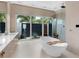Modern bathroom with standalone tub and access to outdoor shower at 424 Bowdoin Cir, Sarasota, FL 34236