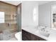 Bathroom features glass enclosed shower, wood accent wall, and dark wood vanity at 424 Bowdoin Cir, Sarasota, FL 34236