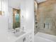 Bathroom features glass enclosed shower with soaking tub, white vanity and modern mirror at 424 Bowdoin Cir, Sarasota, FL 34236