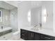 A bright bathroom features sleek vanity, glass-enclosed shower, and contemporary lighting fixtures at 424 Bowdoin Cir, Sarasota, FL 34236