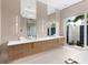 Light-filled bathroom featuring double sinks and access to outdoor shower at 424 Bowdoin Cir, Sarasota, FL 34236