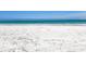 A beautiful white sand beach scene featuring the light blue ocean water and a clear horizon at 424 Bowdoin Cir, Sarasota, FL 34236