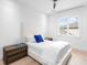 Bright bedroom features a large window, hardwood floors, and simple but comfortable furnishings at 424 Bowdoin Cir, Sarasota, FL 34236