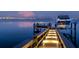 Waterfront dock featuring lighting, boat lift and seating, with views of the water and city skyline at 424 Bowdoin Cir, Sarasota, FL 34236