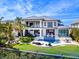 Expansive backyard featuring a pool, lounge areas, and lush landscaping, perfect for outdoor enjoyment at 424 Bowdoin Cir, Sarasota, FL 34236