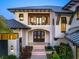 Beautiful elevation of a two-story home with a balcony, large windows, and a well-manicured lawn at 424 Bowdoin Cir, Sarasota, FL 34236
