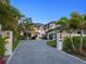 Stately home with a manicured lawn, a circular driveway, and lush tropical landscaping at 424 Bowdoin Cir, Sarasota, FL 34236