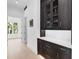 Bright hallway featuring custom cabinetry with glass doors and modern hardware at 424 Bowdoin Cir, Sarasota, FL 34236