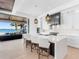 Modern kitchen with a spacious island, bar seating, sleek countertops, and glass doors to a waterfront patio at 424 Bowdoin Cir, Sarasota, FL 34236