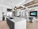 Open living space with a large kitchen island, a dining area, and a media center in a modern home at 424 Bowdoin Cir, Sarasota, FL 34236