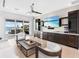 Bright living room with modern furniture, wet bar, and sliding doors opening to a patio at 424 Bowdoin Cir, Sarasota, FL 34236