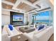 Stunning living room with ocean views, a fireplace, and a modern entertainment center at 424 Bowdoin Cir, Sarasota, FL 34236