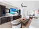 Open-concept living room with built-in bar, modern furniture, and view of the water at 424 Bowdoin Cir, Sarasota, FL 34236