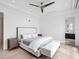Bright main bedroom features modern ceiling fan, light hardwood floors, and ensuite bathroom access at 424 Bowdoin Cir, Sarasota, FL 34236