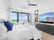 Bright bedroom with water view through wide sliding glass doors at 424 Bowdoin Cir, Sarasota, FL 34236
