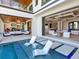 Expansive indoor-outdoor living with pool and lounge chairs, offering a seamless transition from interior to exterior at 424 Bowdoin Cir, Sarasota, FL 34236
