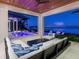 Enclosed patio includes furniture, a ceiling fan, and opens to the pool, bay, and city views at 424 Bowdoin Cir, Sarasota, FL 34236
