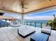 Relaxing outdoor patio with comfortable seating, ceiling fan, and scenic water views at 424 Bowdoin Cir, Sarasota, FL 34236