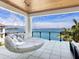 Cozy hanging daybed with comfortable seating and amazing water views on an outdoor patio at 424 Bowdoin Cir, Sarasota, FL 34236