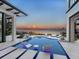 Backyard oasis featuring a modern pool, lounge chairs, and stunning waterfront views at sunset at 424 Bowdoin Cir, Sarasota, FL 34236