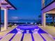 Evening view of luxury pool and lounge area showcasing vibrant LED lighting and scenic bay views at 424 Bowdoin Cir, Sarasota, FL 34236
