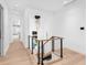 Bright foyer features wood staircase with metal railing, chandelier, and hardwood floors at 424 Bowdoin Cir, Sarasota, FL 34236