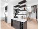 Stylish staircase adjacent to wine storage and a stainless-steel refrigerator in a modern home at 424 Bowdoin Cir, Sarasota, FL 34236