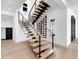 Modern staircase with wood treads, metal railings, and a built-in wine rack for stylish storage at 424 Bowdoin Cir, Sarasota, FL 34236