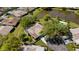 Aerial view of a home near a lake showcasing manicured landscaping, a pool, and verdant trees at 4463 Atwood Cay Pl # 22, Sarasota, FL 34233