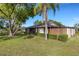 A tranquil backyard offers a view of the home, lush greenery, and a serene pond at 4463 Atwood Cay Pl # 22, Sarasota, FL 34233