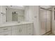 Bright bathroom features white cabinetry, a marble countertop, an updated mirror and shower at 4463 Atwood Cay Pl # 22, Sarasota, FL 34233