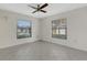 Bright bedroom with tile floors, ceiling fan, and two windows offering natural light at 4463 Atwood Cay Pl # 22, Sarasota, FL 34233