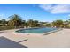 Community pool surrounded by lounge chairs, palm trees, and lush landscaping at 4463 Atwood Cay Pl # 22, Sarasota, FL 34233