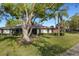 Beautiful home featuring a screened-in porch, lush greenery, and mature shade trees at 4463 Atwood Cay Pl # 22, Sarasota, FL 34233